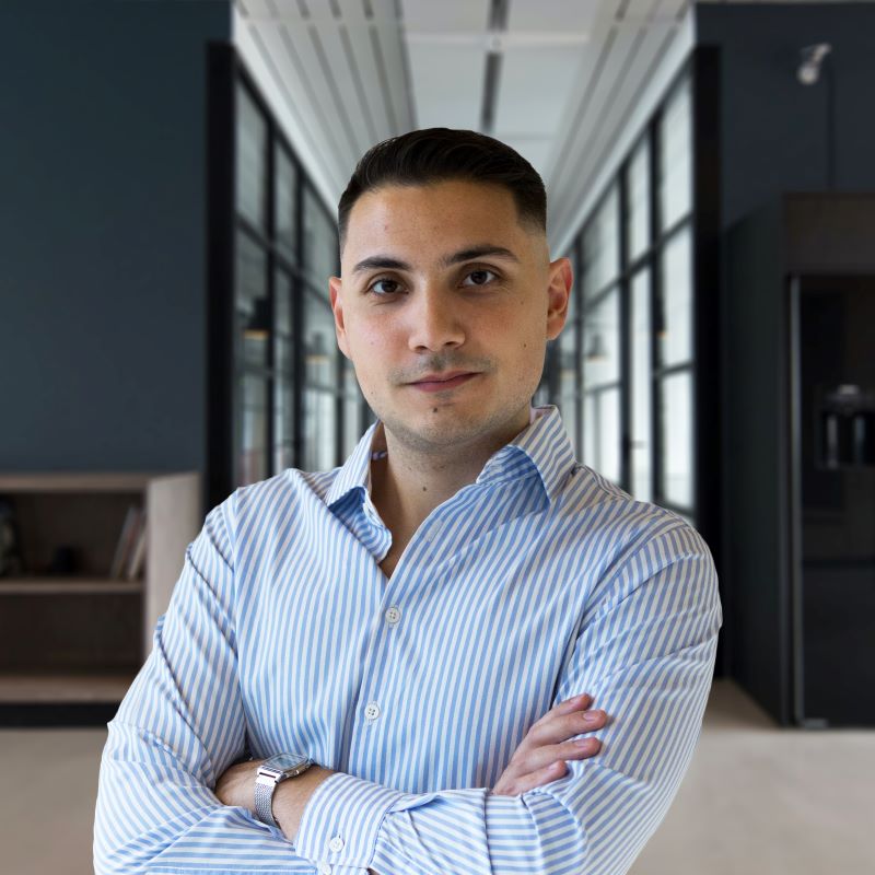 George Melissourgos in an office, looking directly at the camera.